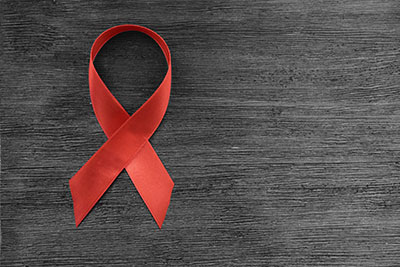Red Aids Ribbon in Hand